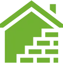 A green house with a brick wall underneath it.
