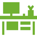 A green icon of a desk with a computer on it.